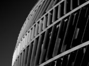 Black-and-white close-up of a building with repeating vertical fins